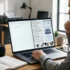 Creator working on a laptop with AI-generated product descriptions and digital product mockups on screen
