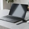 Split concept image of a Microsoft enterprise desk hub device beside a consumer smartwatch and smart glasses, representing Microsoft's wearables gap